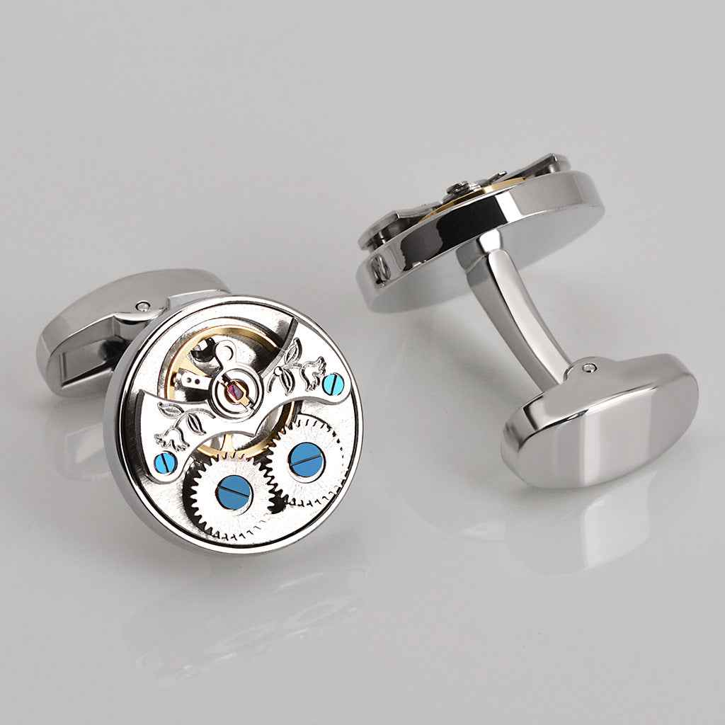 Manschettenknöpfe mit offenem Tourbillon-Uhrwerk, silberfarben, blaues Detail.