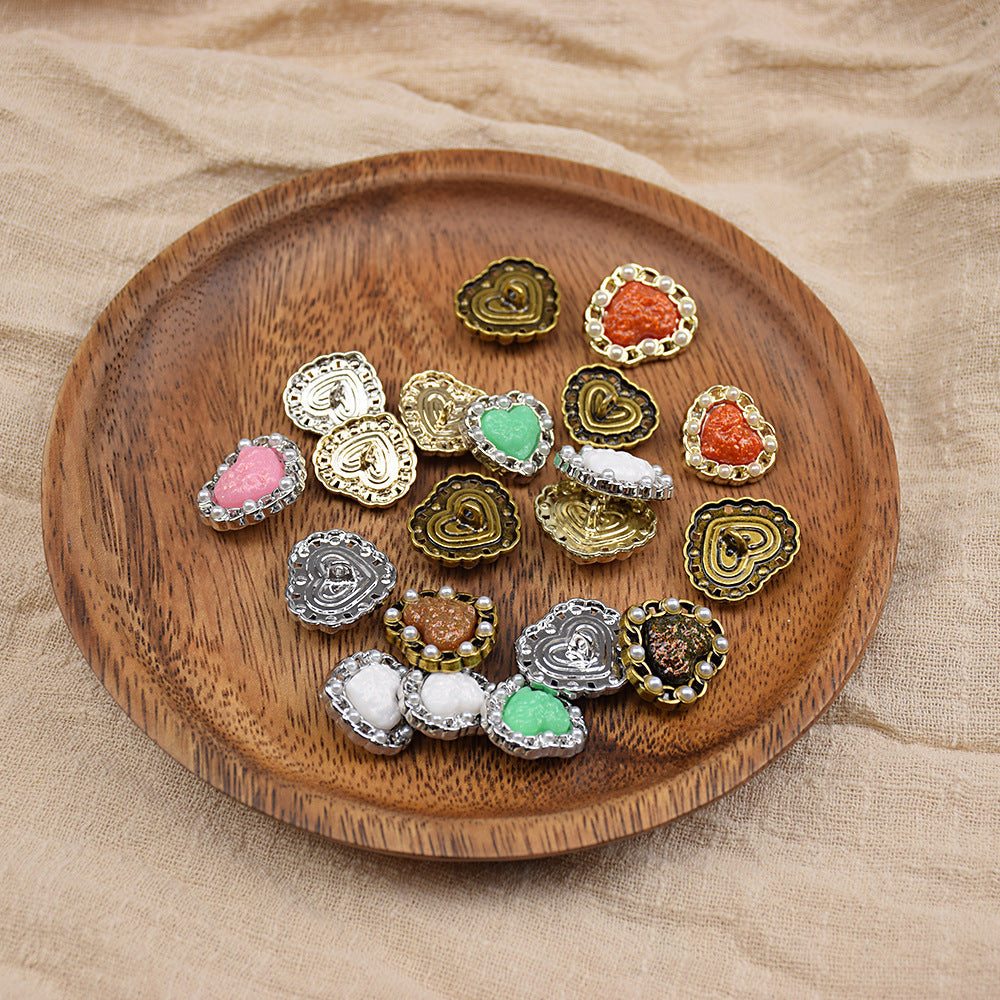 Assorted heart-shaped resin buttons with pearl trim, including green, pink, red, and white
