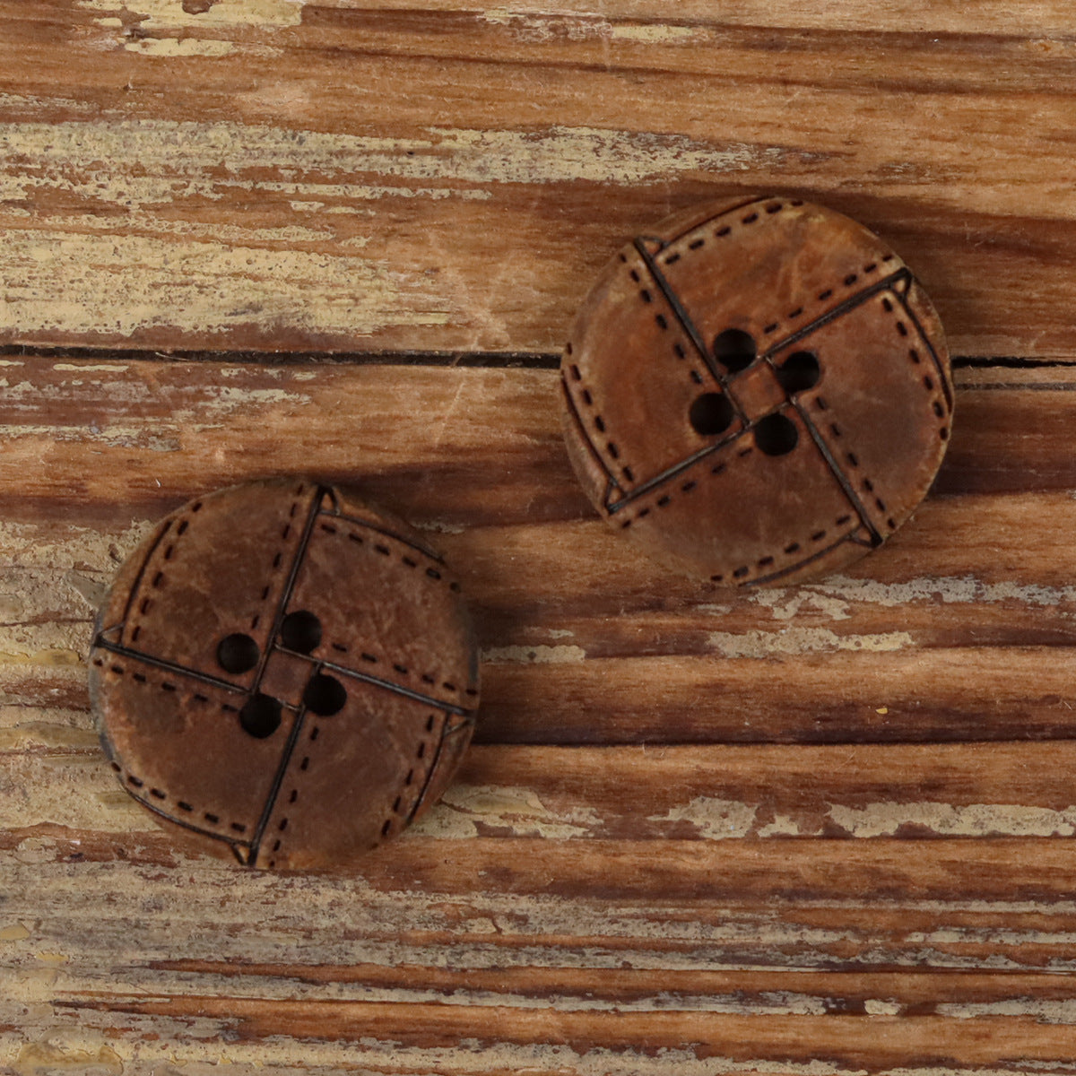 Round 4-hole horn buttons with geometric engraved bands and stitch detailing
