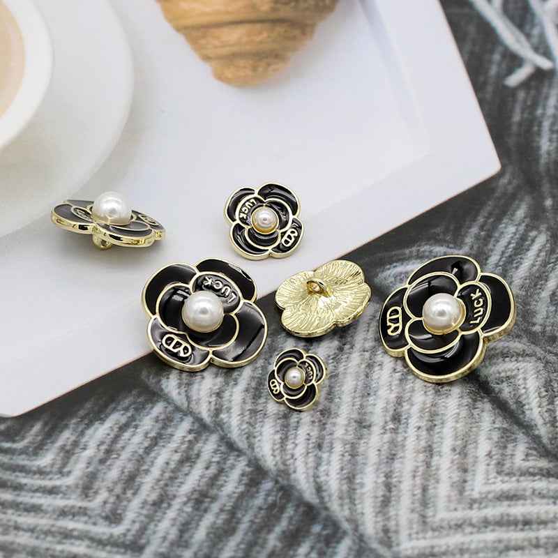Assorted pearl petal metal shank buttons, black and white enamel with gold prongs and pearl