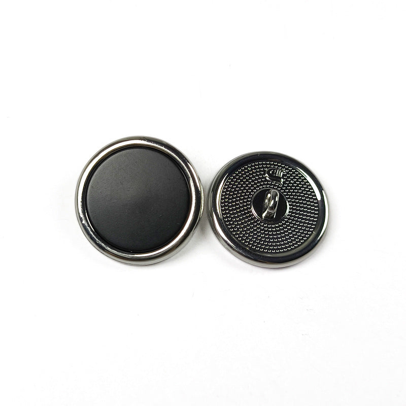 Round metal shank button set, black face with gold rim and engraved shank