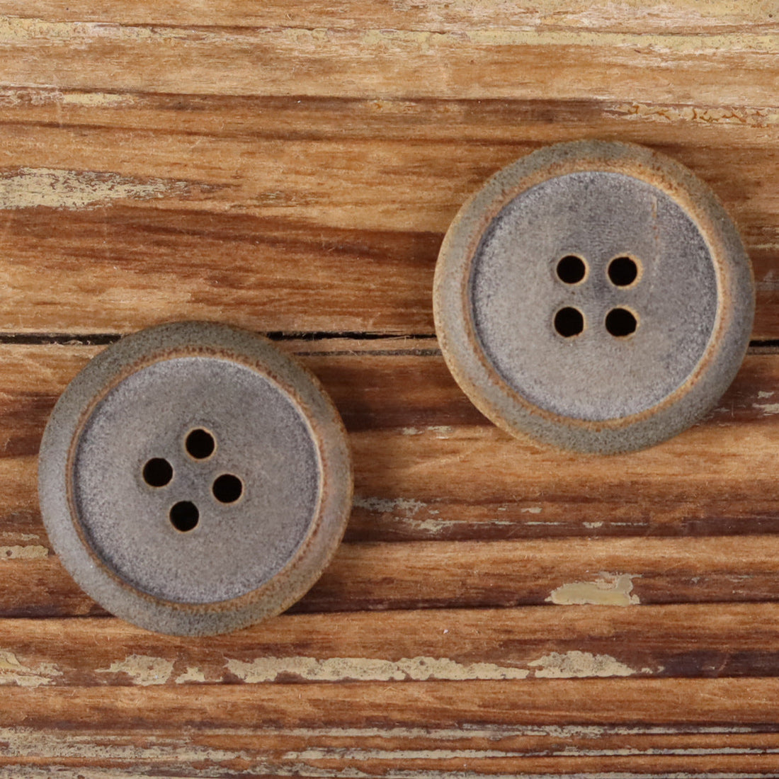 Matte buffalo horn button, burnt edge, four-hole design