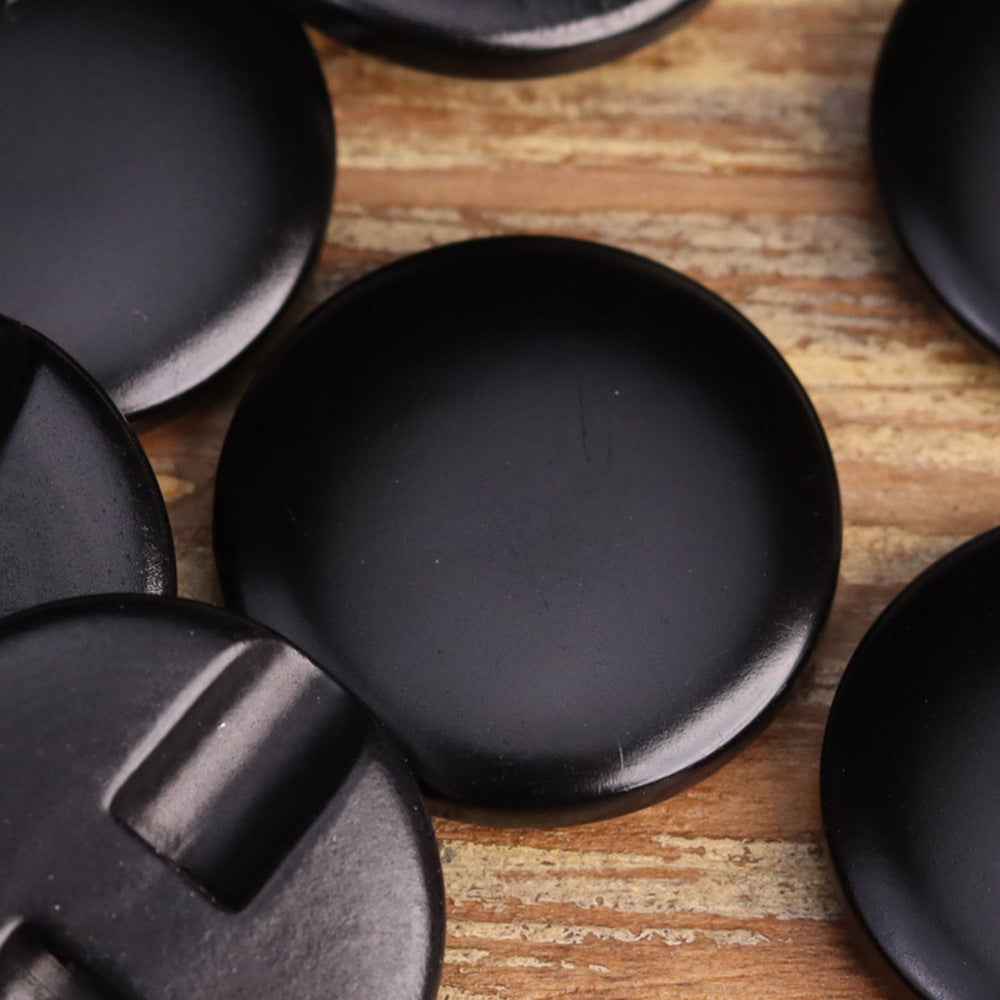 Set of black round custom apparel buttons with metal shank backs