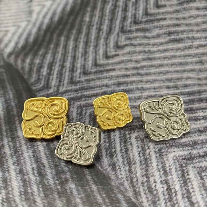 Square Chinese-style metal buttons in matte gold and silver, frosted swirl faces
