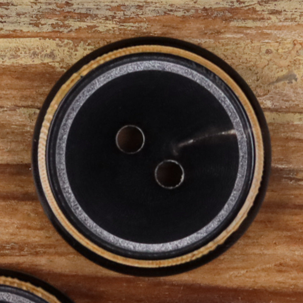 Two-hole round black horn button with gray-speckled rim and matte finish