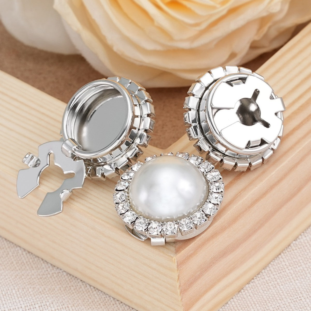 Multiple round rhinestone snap buttons with pearl centers and metal clamp backs