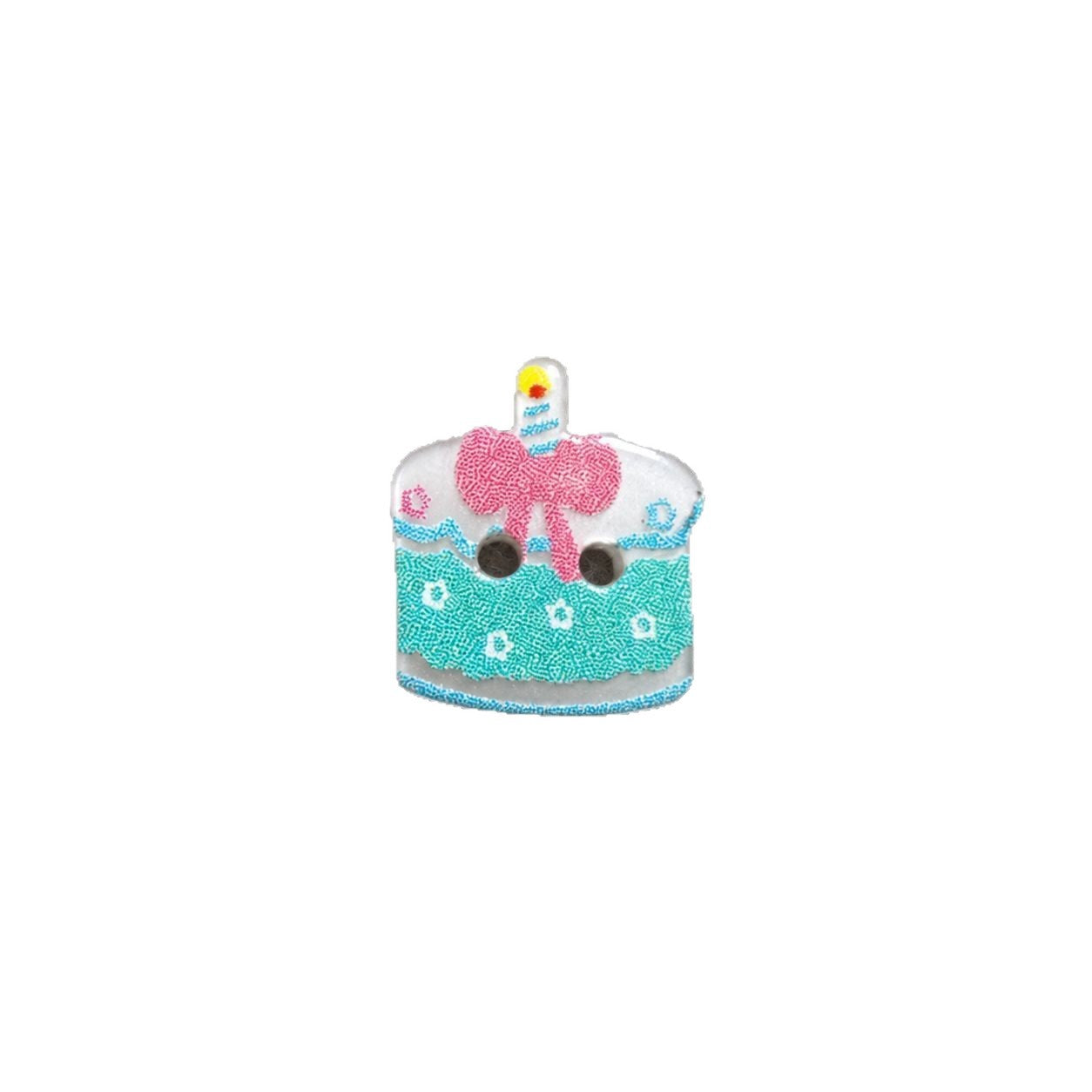 Resin cake button with light green base, pink bow and candle, two holes