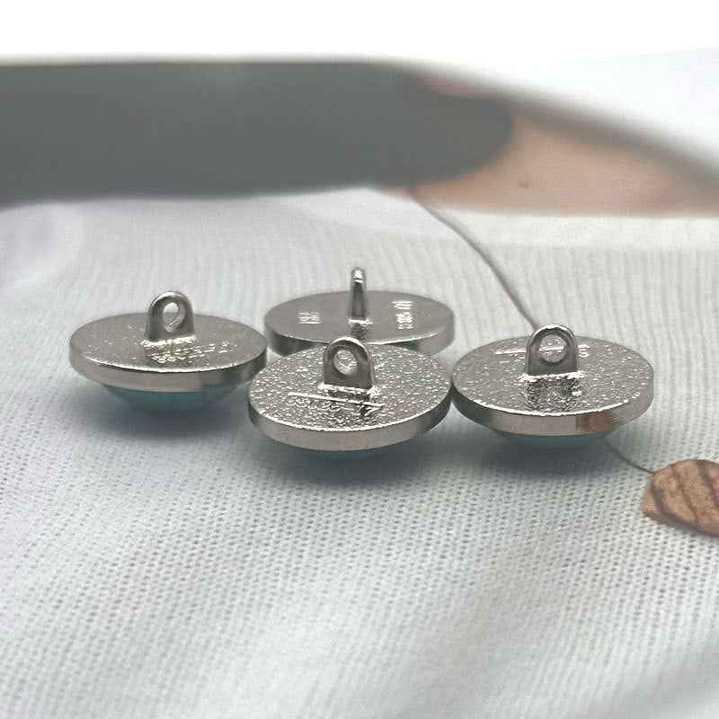 Turquoise stone-look round sewing buttons with silver metal rim and cracked pattern