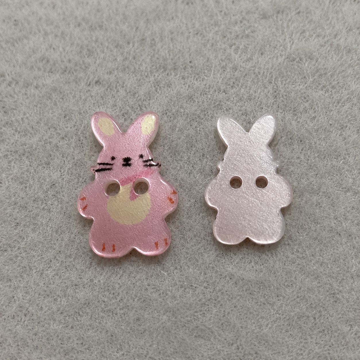 Pink and white bunny resin sew-on buttons, each with two holes