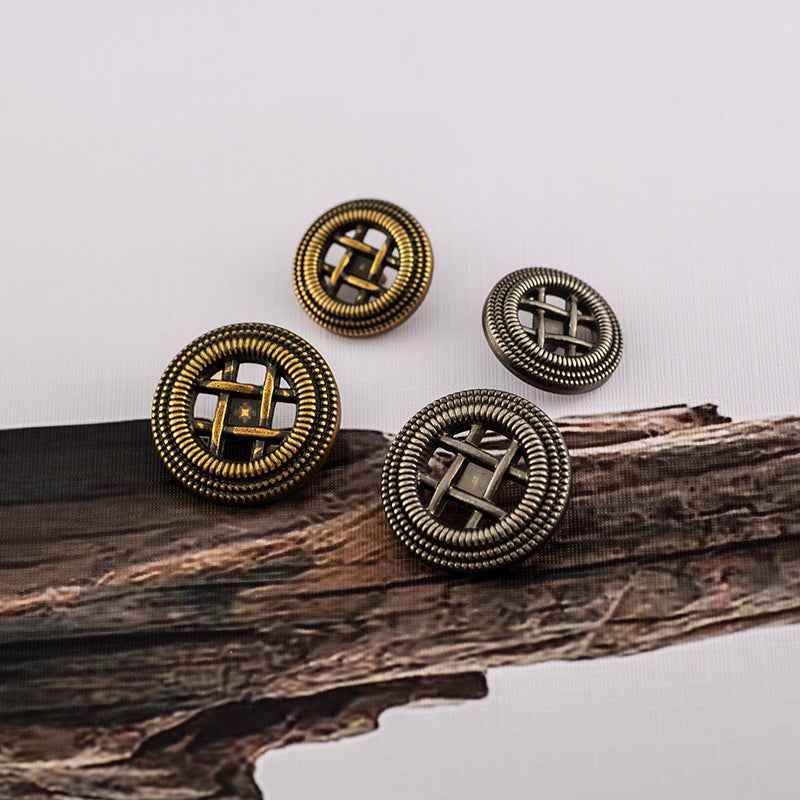 Set of four round matte metal shank buttons with woven borders: two gold, two silver, front view.
