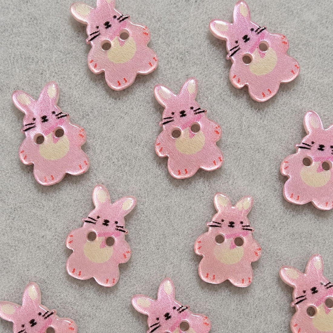 Pink bunny resin sew-on button with two holes, cute face detail
