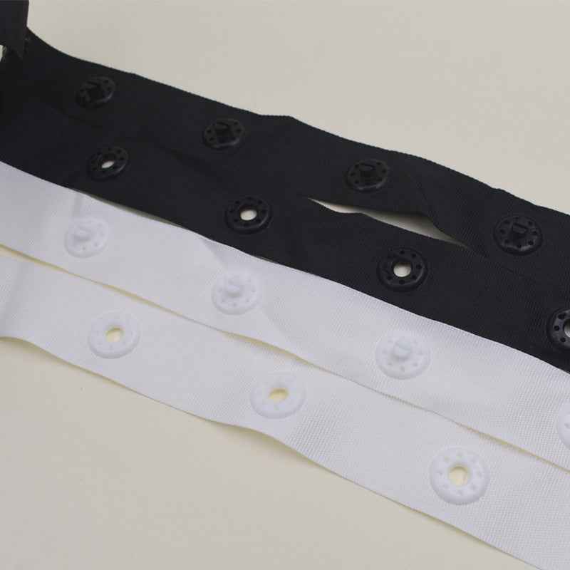 Black and white snap fastener button tape strips with evenly spaced snap buttons
