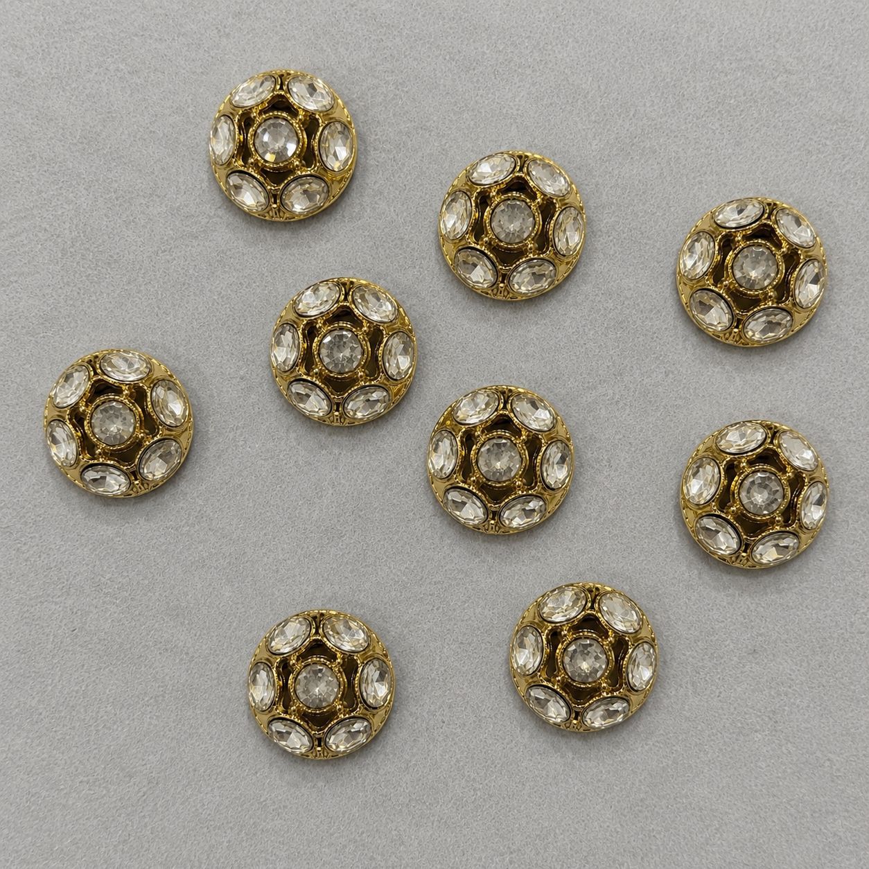 Gold domed metal shank buttons with clear rhinestone inlay, multiple pieces shown