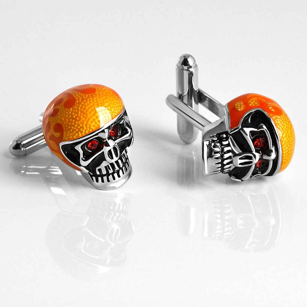 Skull-Manschettenknöpfe mit orange Strass-Drip-Optik und schwarzem Gesicht, rote Steine