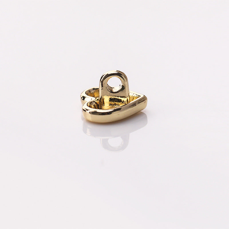 Light gold heart-shaped metal shank button, underside with loop shank