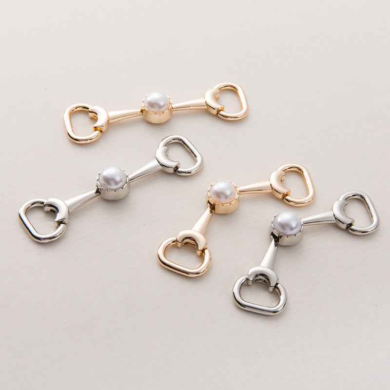 Assorted shoe buckle chain pieces: pearl center with heart-shaped loop ends, gold and silver
