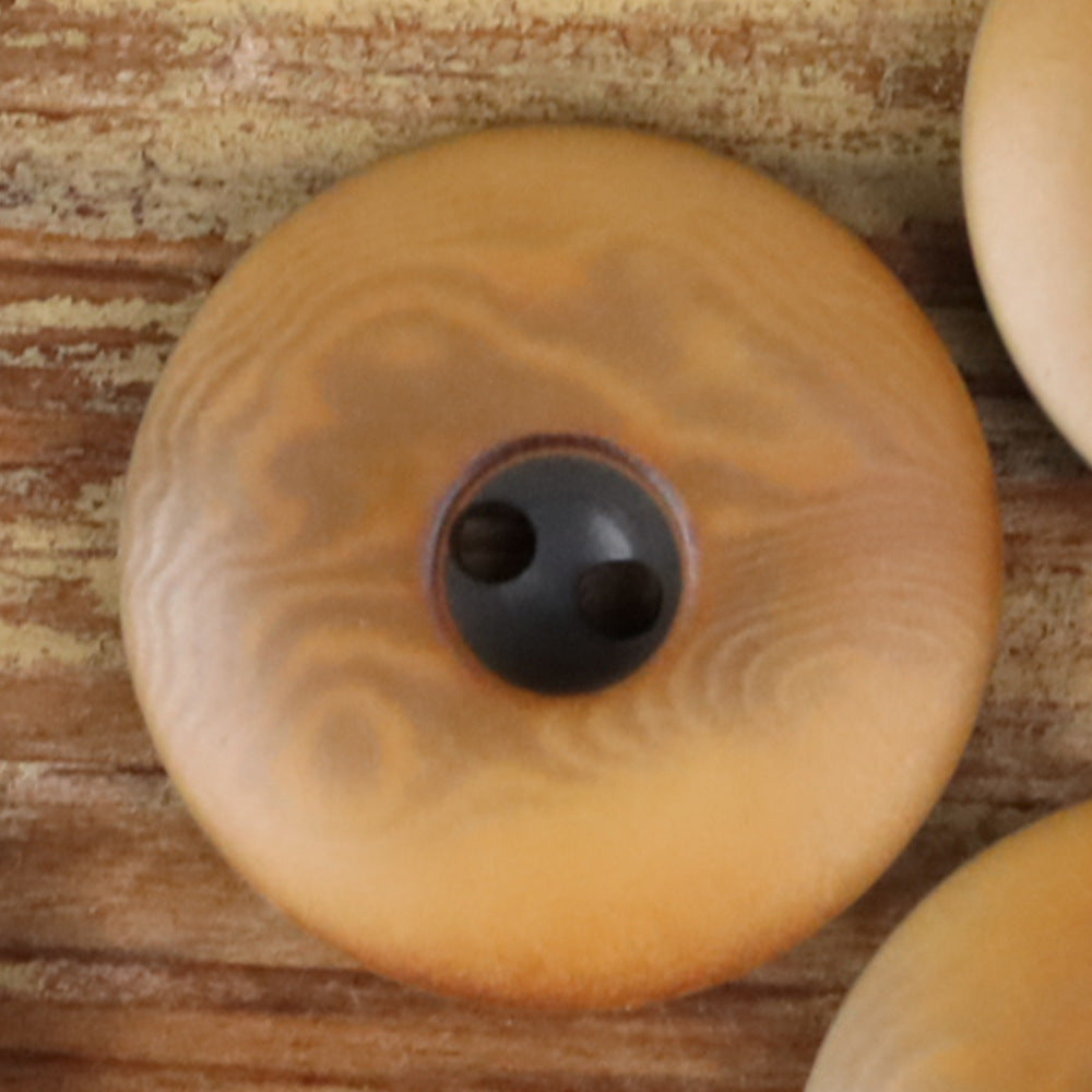Round 2-hole seed button with thick edge, tan wood-grain and dark holes