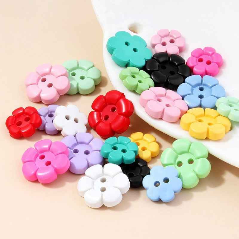 Assorted colorful flower-shaped 2-hole plastic buttons, multiple colors on display