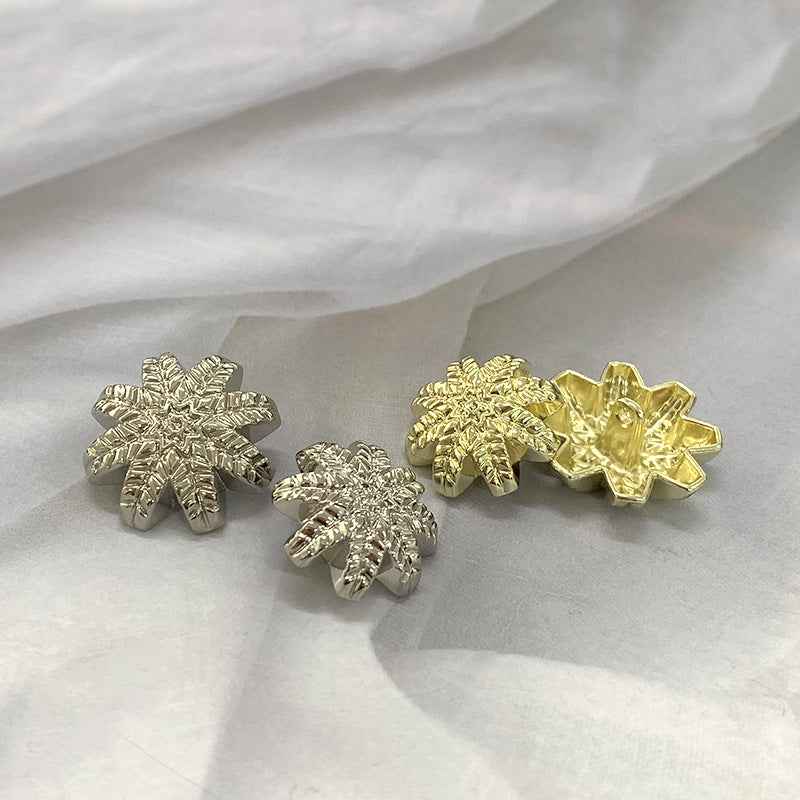 Gold and Silver metal leaf shank buttons, three snowflake-style buttons