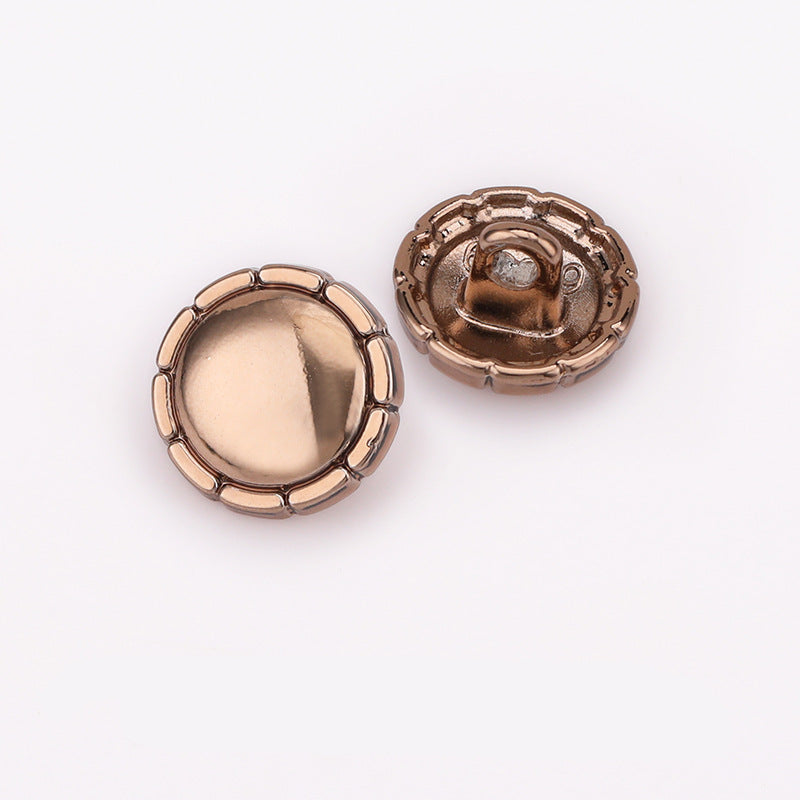 Underside view: domed metal shirt buttons in light gold and dark tones