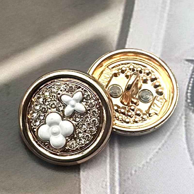 Round two-tone metal shank button, white clover on rhinestone field, gold-tone back