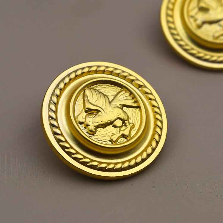 Gold round metal shank button with gryphon relief, braided outer ring detail