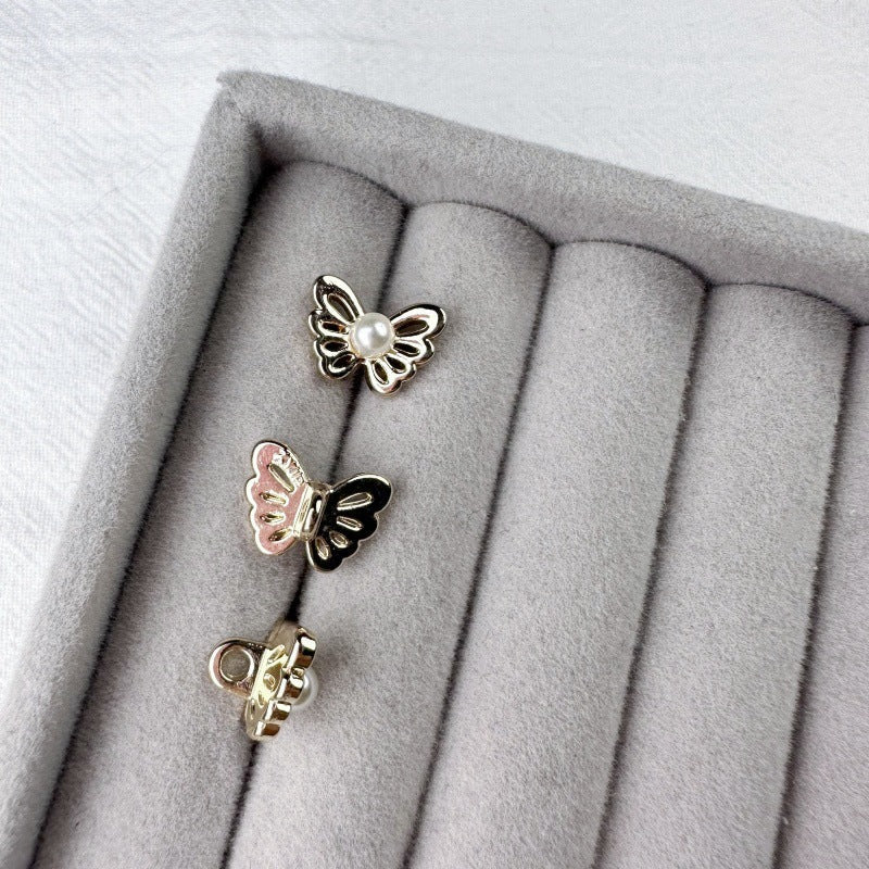 Butterfly pearl metal shank buttons in display tray, mixed gold and silver tones