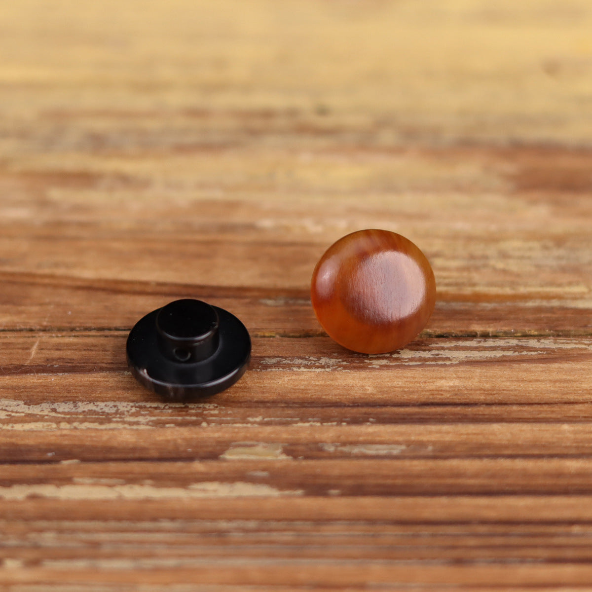 Round horn buttons pair, black back and dark brown front, glossy domed surface