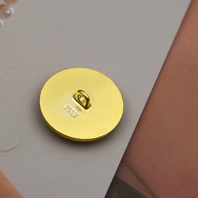 Back view of gold round metal shank button with centered loop shank
