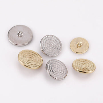 Spiral concave metal shank buttons in light gold and silver, textured circular face