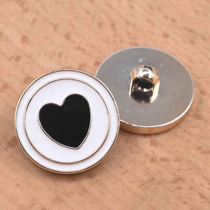 Heart-shaped black front 21/23mm plastic shank button with silver rim and shank backing
