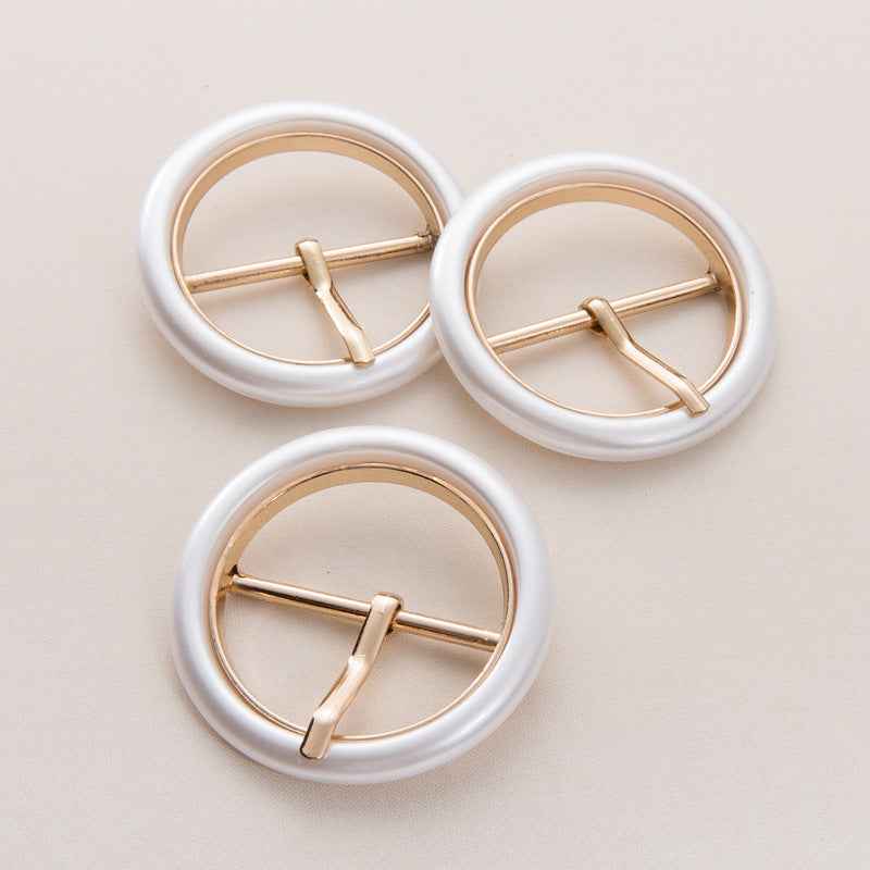 Set of round pearl white resin belt buckles with gold-toned metal frames and bars