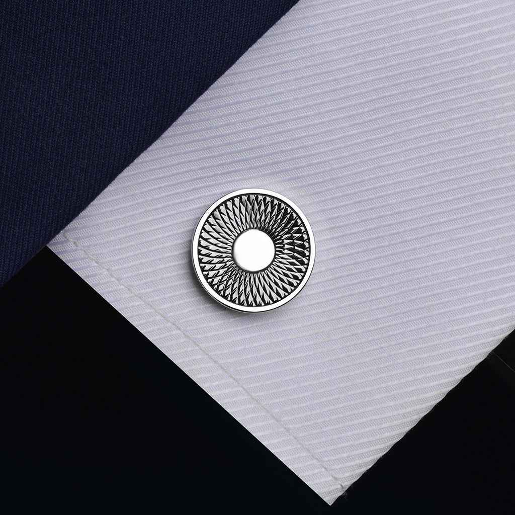 Silver round cufflink with textured outer ring and smooth circular center