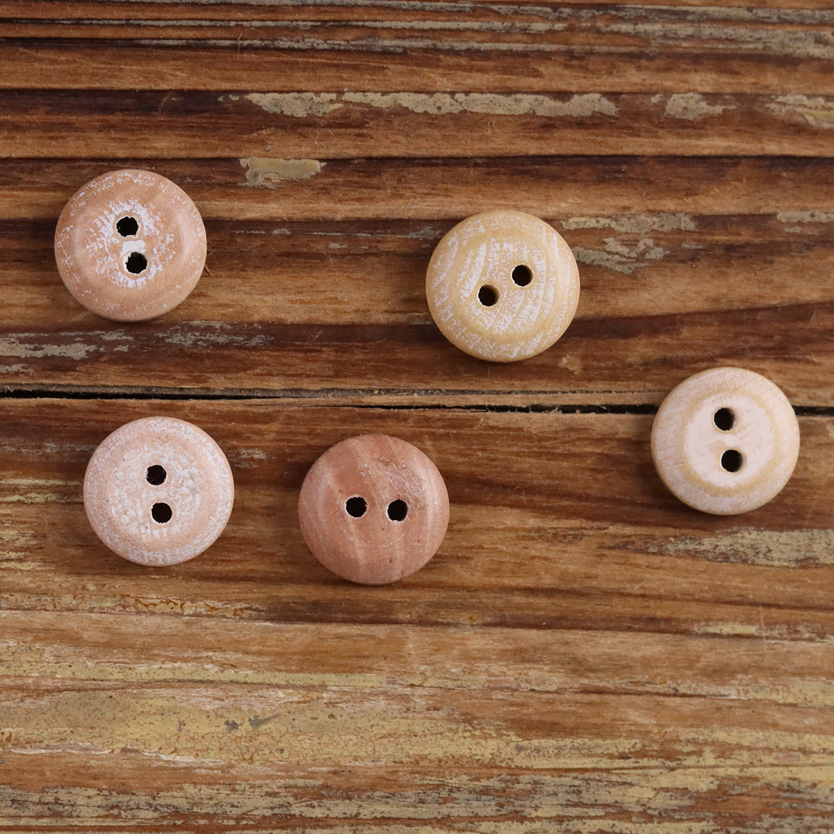Round iridescent wood button, peach tones, two holes