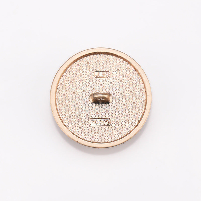 Back view of cat-eye metal shank button with JDB logo and 79363 number, gold tone