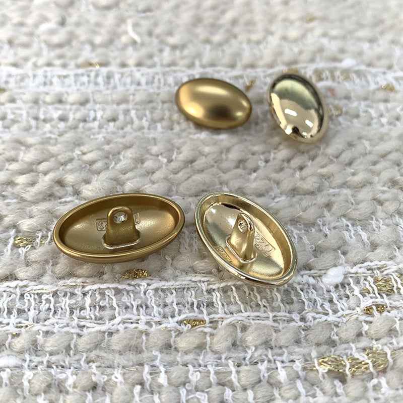 Oval gold alloy shank buttons showing undersides with pin posts, 2-piece view