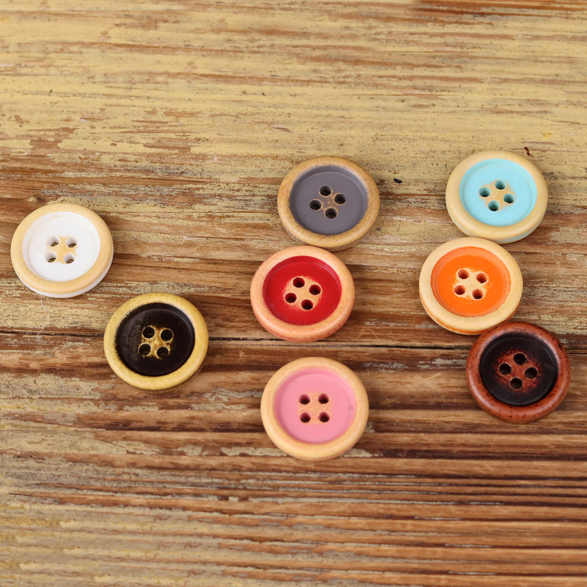 Set of round 4-hole wood buttons in black, red, pink, and orange tones