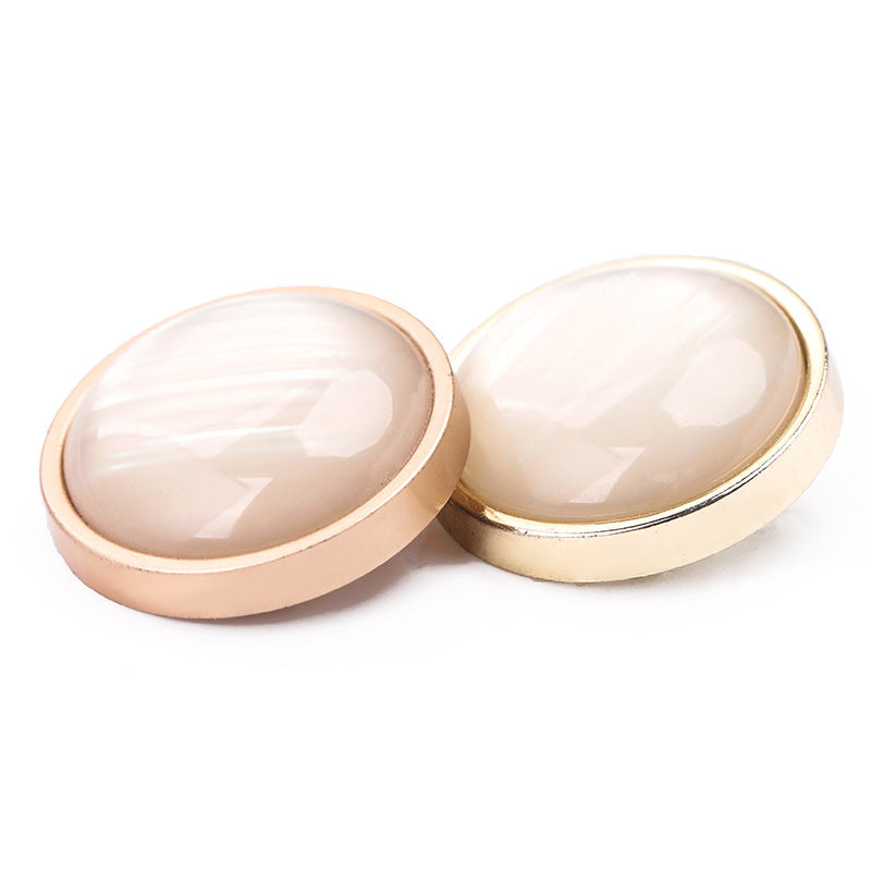 Cat-eye stone buttons: one with shiny light gold rim, one with matte gold rim, pearly centers