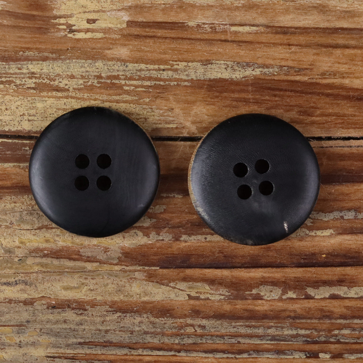 Round 4-hole button set in dark charcoal with smooth horn finish