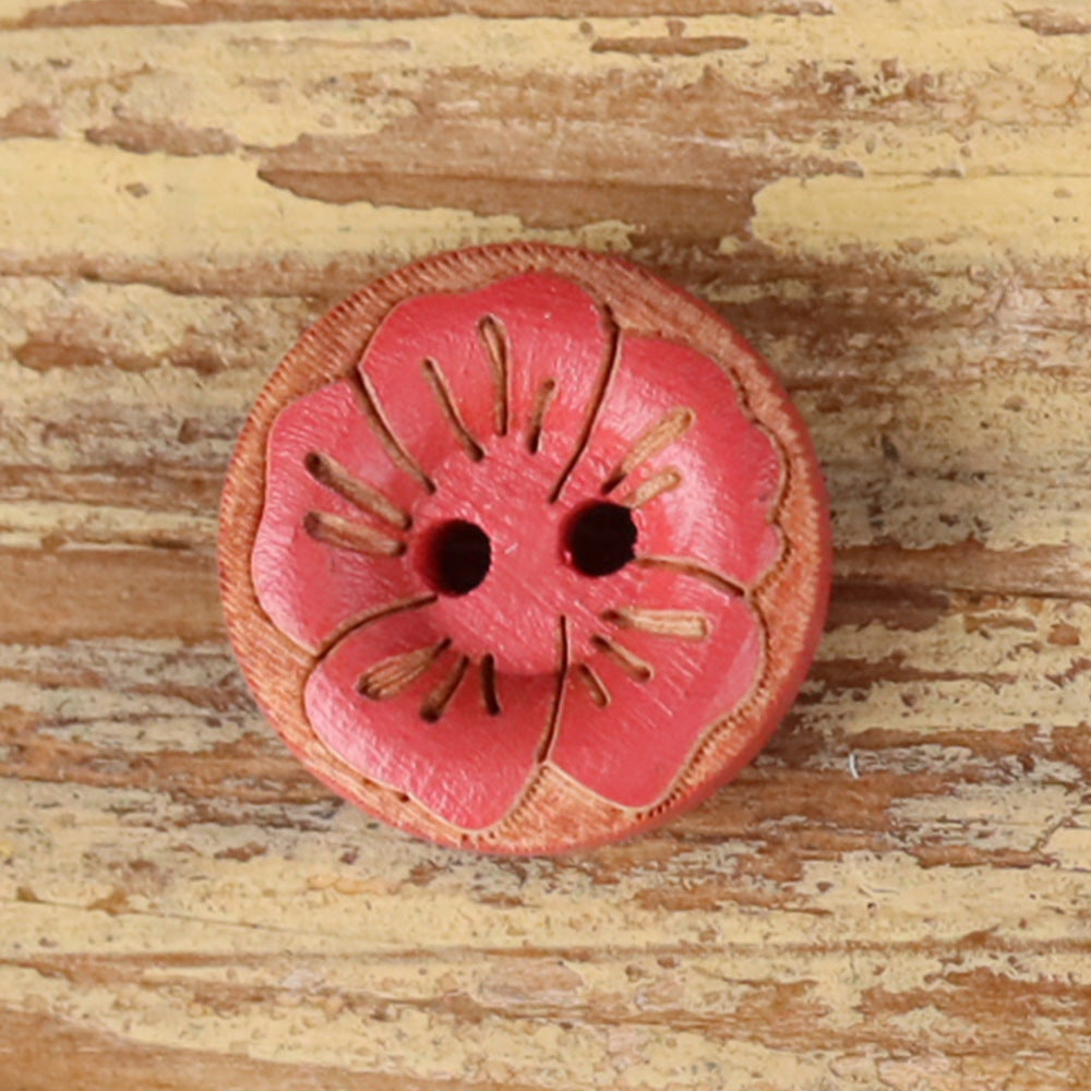 Round 2-hole wood button with painted floral pattern in red-pink with dark center holes.