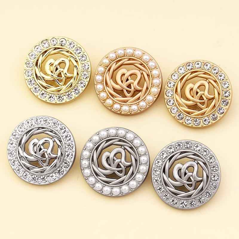 Assorted rhinestone and pearl coat shank buttons in gold and silver spiral designs