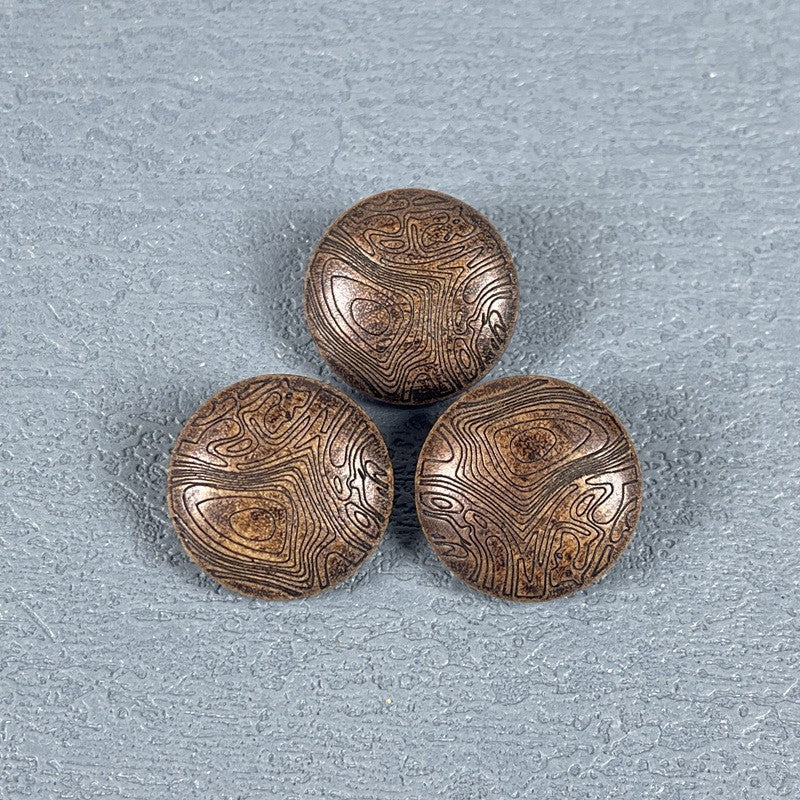 Set of three round wood shank buttons with carved mushroom-grain texture