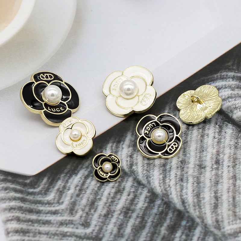 Black and white pearl petal metal shank buttons with gold rims and glossy center pearls