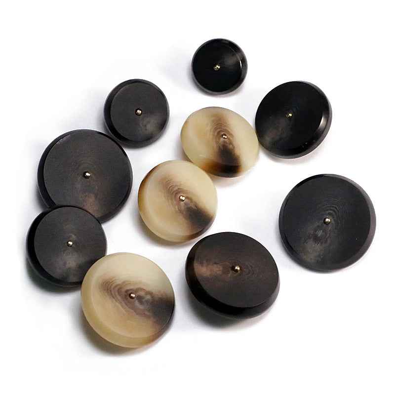 Round resin buttons in khaki and black with flat faces and metal shanks
