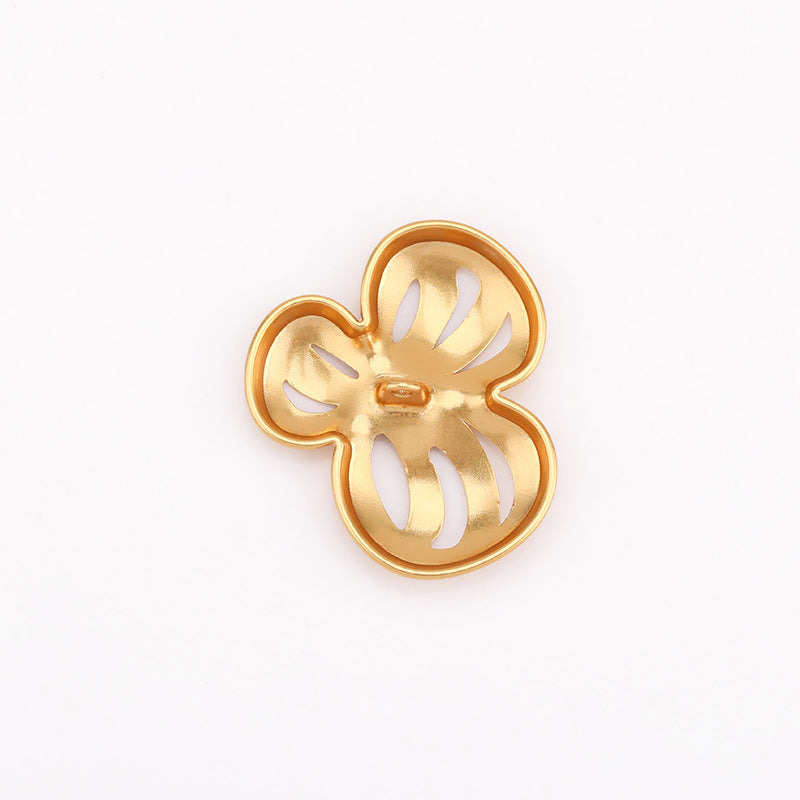 Gold-tone hollow flower metal shank buttons, underside view with loop shank