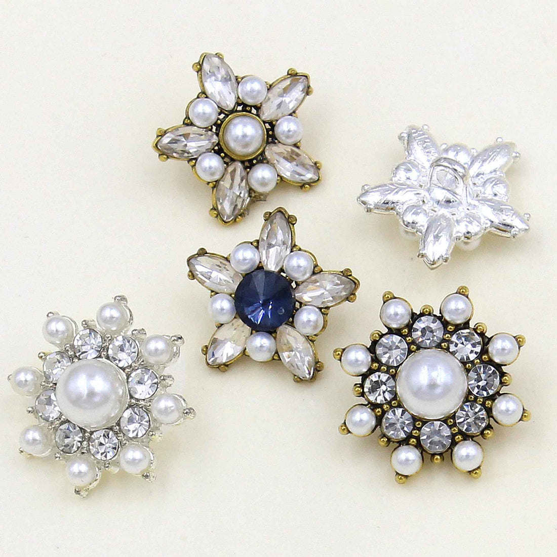 Star-shaped pearl crystal button set with mixed clear crystals, pearls, and gold-tone bases