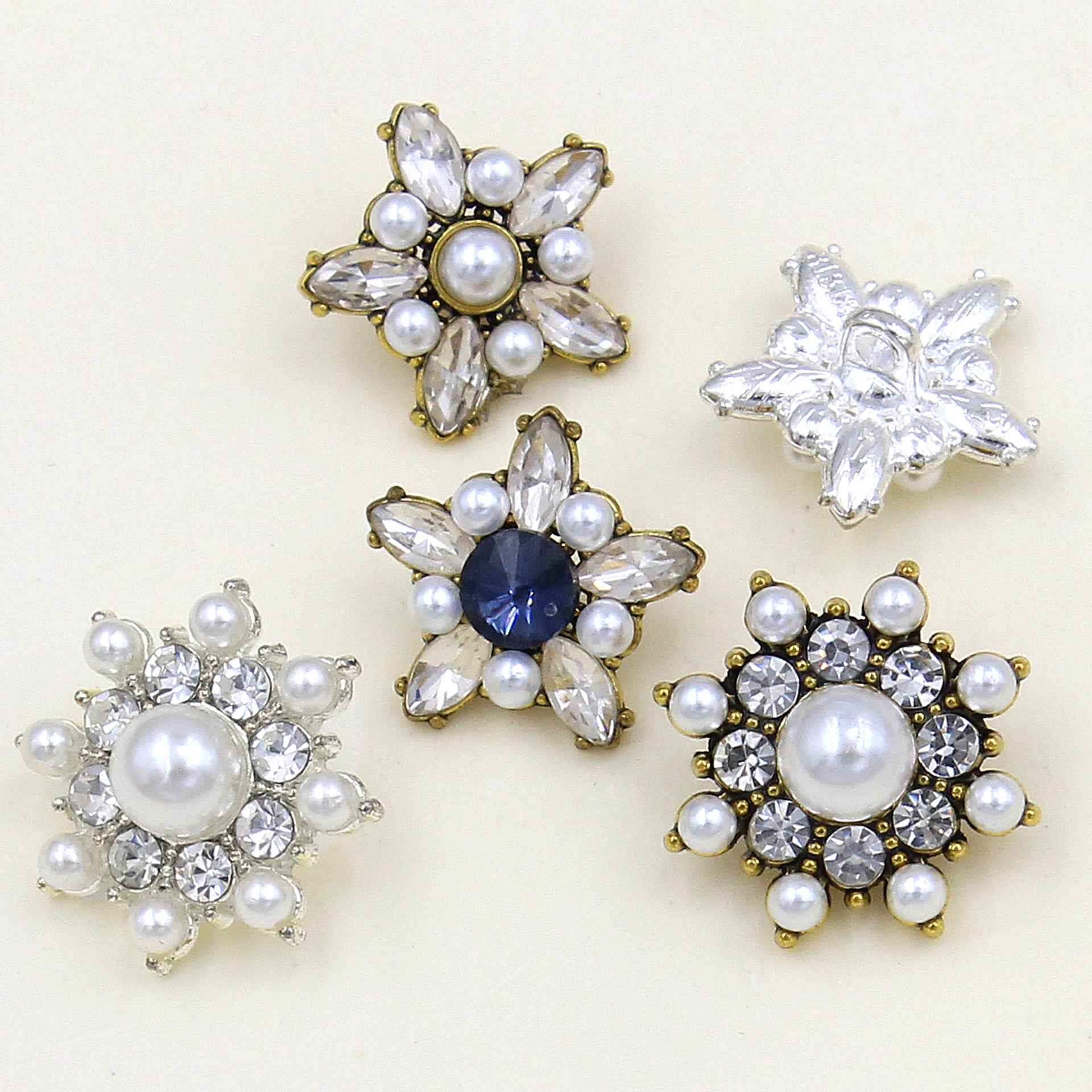 Star-shaped pearl crystal button set with mixed clear crystals, pearls, and gold-tone bases