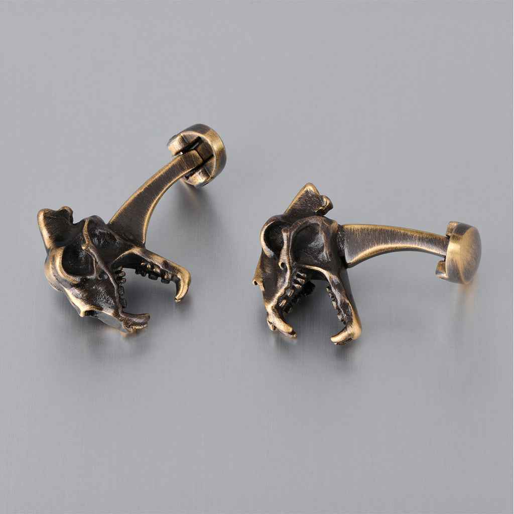 Bronze dinosaur skull cufflinks for men, hinged backs visible, two-piece set
