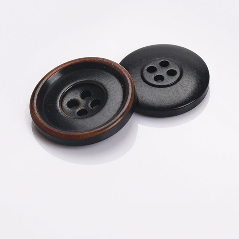 Pair of round two-tone 4-hole sewing buttons: black with brown rim detail