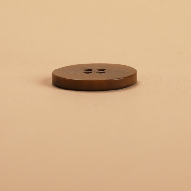 Coffee-brown flat 4-hole button, side profile